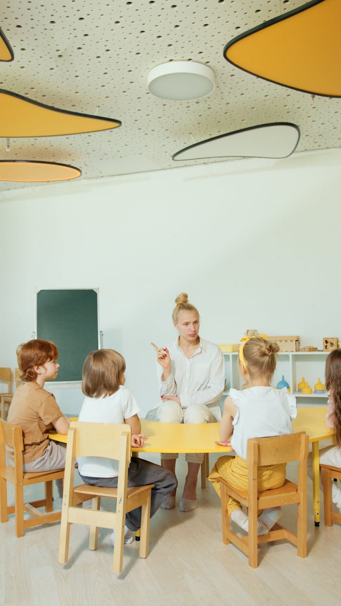 Crafting Captivating Headlines: Your awesome post title goes here Children gathered around a teacher in a vibrant, modern classroom setting.